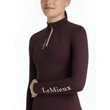 A maroon lemieux young rider classique long-sleeved base layer top with high collar and white branding on chest and sleeve