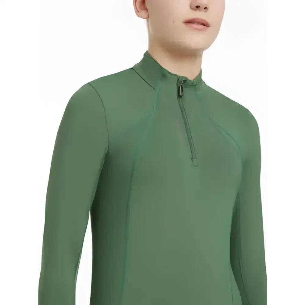 A sleek olive green lemieux young rider classique base layer with long sleeves high collar and zipper closure