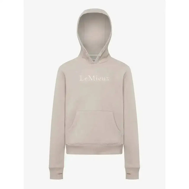 A soft beige lemieux young rider classique hoodie with a subtle embroidered logo across the chest