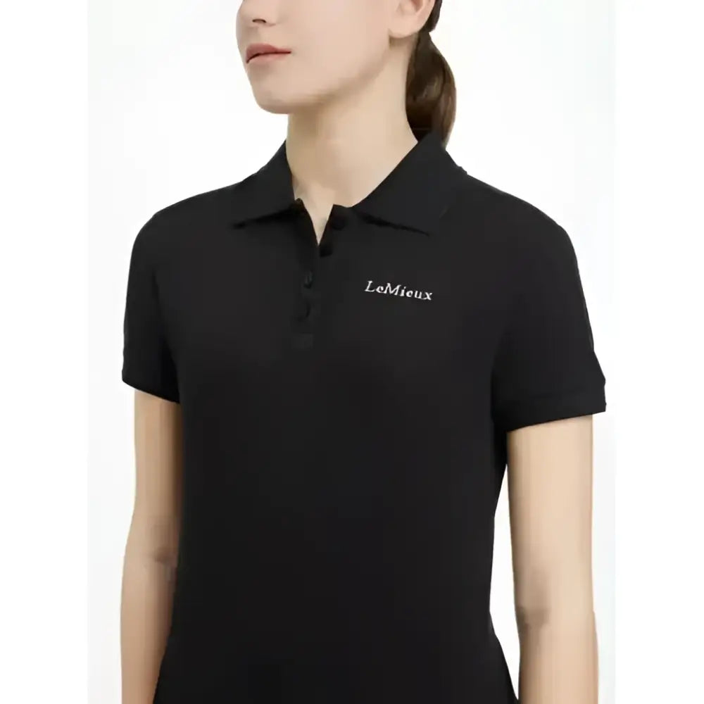 Black short-sleeved lemieux young rider classique polo shirt with subtle embroidered logo on the left chest