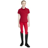 Red short-sleeved lemieux young rider classique polo shirt with collar and button placket in chilli color