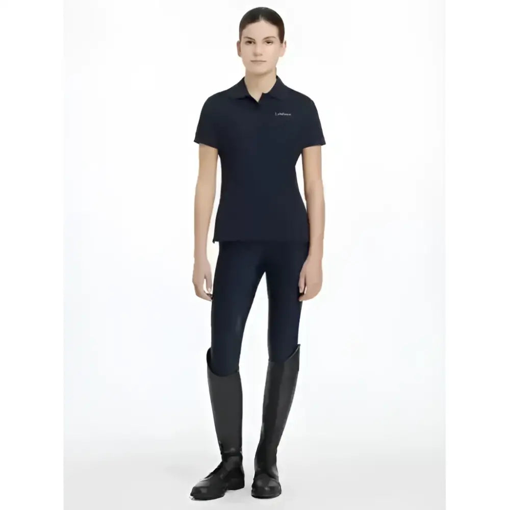 Black short-sleeved lemieux young rider classic polo shirt with subtle embroidered logo on left chest