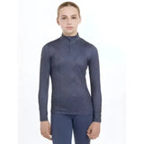 Dark blue long-sleeved lemieux young rider clea base layer with subtle geometric pattern and quarter-zip neckline
