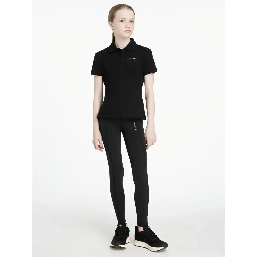 Black short-sleeved polo shirt with subtle embroidered logo perfect for lemieux young rider darla sport legging look