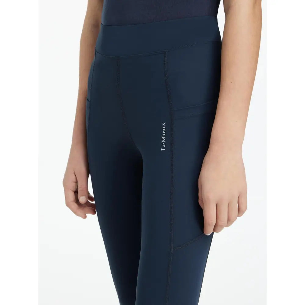 Navy high-waisted sport legging navy with subtle side seam and lemieux young rider logo on thigh darla sport legging