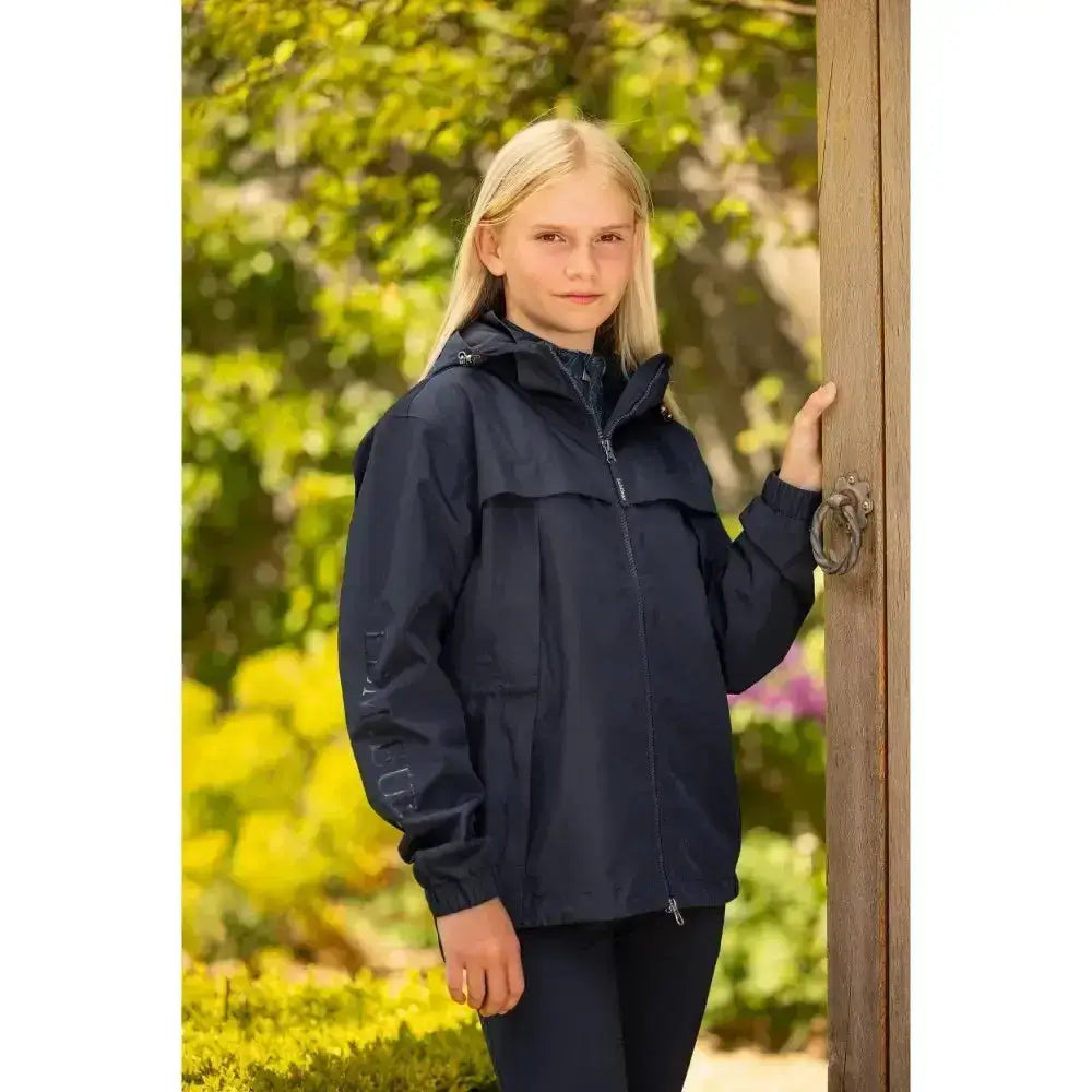 Navy blue lemieux young rider dolcie waterproof jacket with hood and front zipper for young riders wet weather use