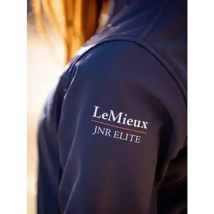 Dark navy blue lemieux young rider elite soft shell jacket with white and red embroidery on the shoulder