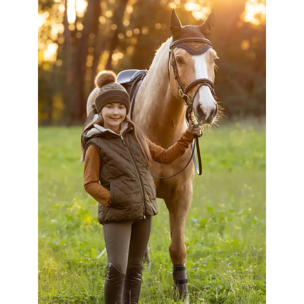 Palomino horse beside person in Lemieux Young Rider Eloise Reversible Winter Gilet Alpine