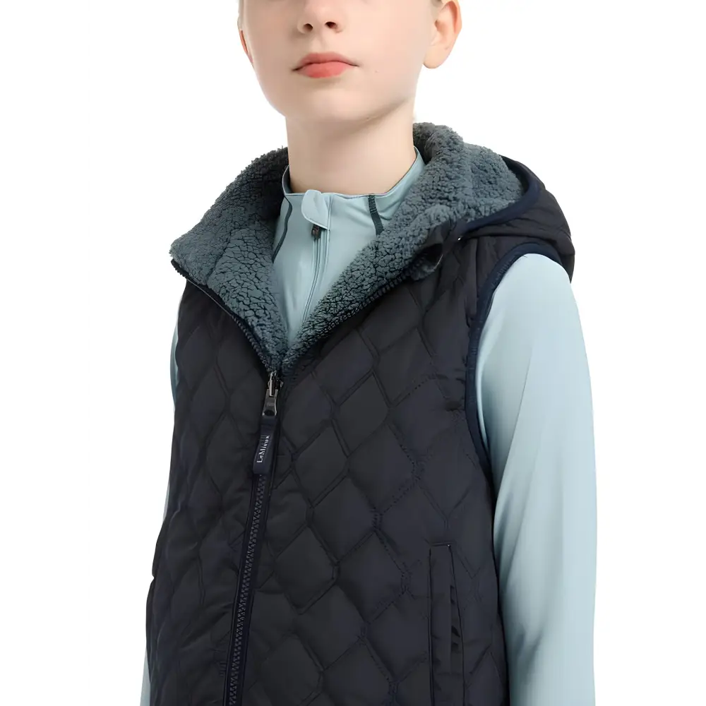 Quilted Navy Vest with Gray Fuzzy Collar over Light Blue Shirt - Lemieux Young Rider Eloise