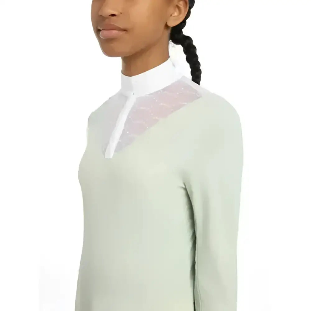 A lemieux young rider eva long sleeve show shirt pistachio with a pale green body, white collar, and sparkly mesh panel