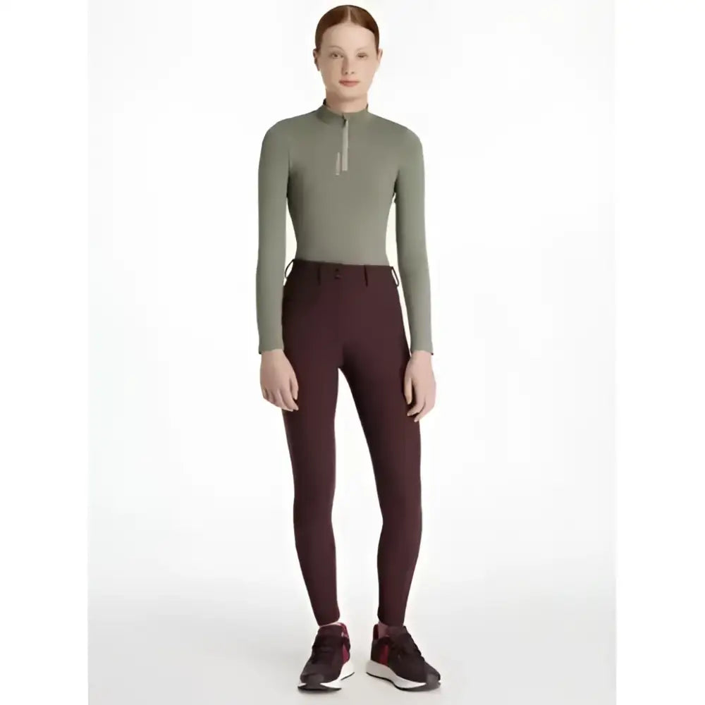 Olive green long-sleeved zip-neck top paired with lemieux young rider seat izzy breeches damson for riding comfort