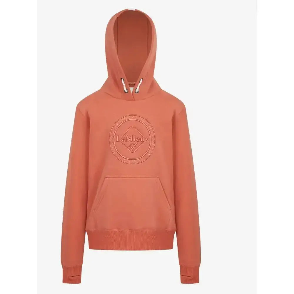 A coral colored lemieux young rider hannah pop over hoodie with subtle embroidered logo and ribbed cuffs