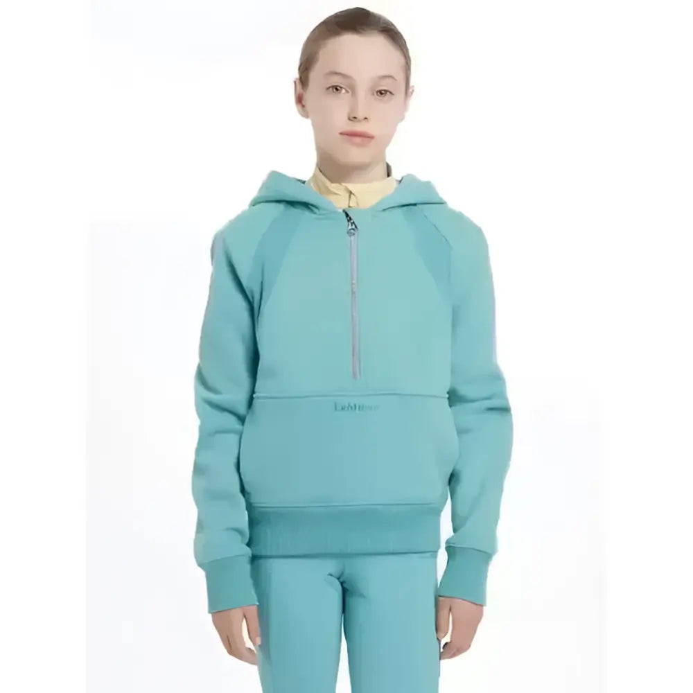 A teal lemieux young rider harriet pop half zip hoodie with a subtle logo on the front pocket in lagoon color