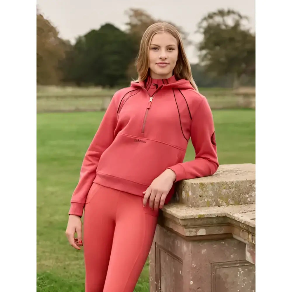 A coral pink cranberry zip hoodie lemieux young rider hettie half zip with black piping details perfect for riders