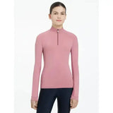 A soft pink lemieux young rider hope lightweight base layer peony with long sleeves and a quarter-zip collar