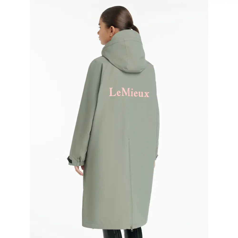 A back view of the lemieux young rider hydroshield robe rosemary in sage green with breathable fabric and pink logo