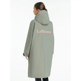 A back view of the lemieux young rider hydroshield robe rosemary in sage green with breathable fabric and pink logo