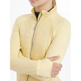A pale yellow quilted lemieux young rider josephine jacket mimosa with a silver zipper and ribbed cuffs