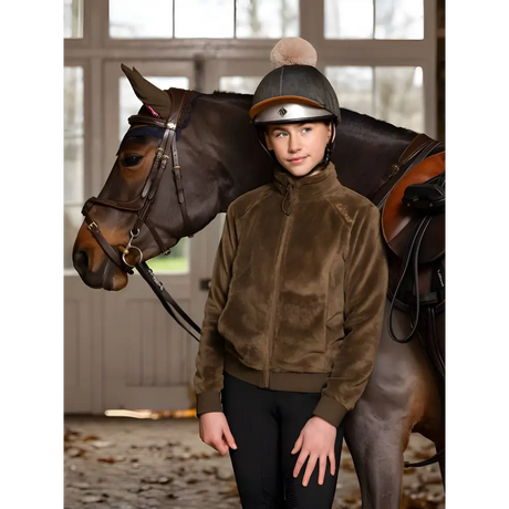 Horse next to a young equestrian in Lemieux Young Rider Libby fleece gear