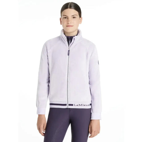 Light lavender lemieux young rider libby fleece lilac zip-up jacket with black trim and lemieux branding at waistband