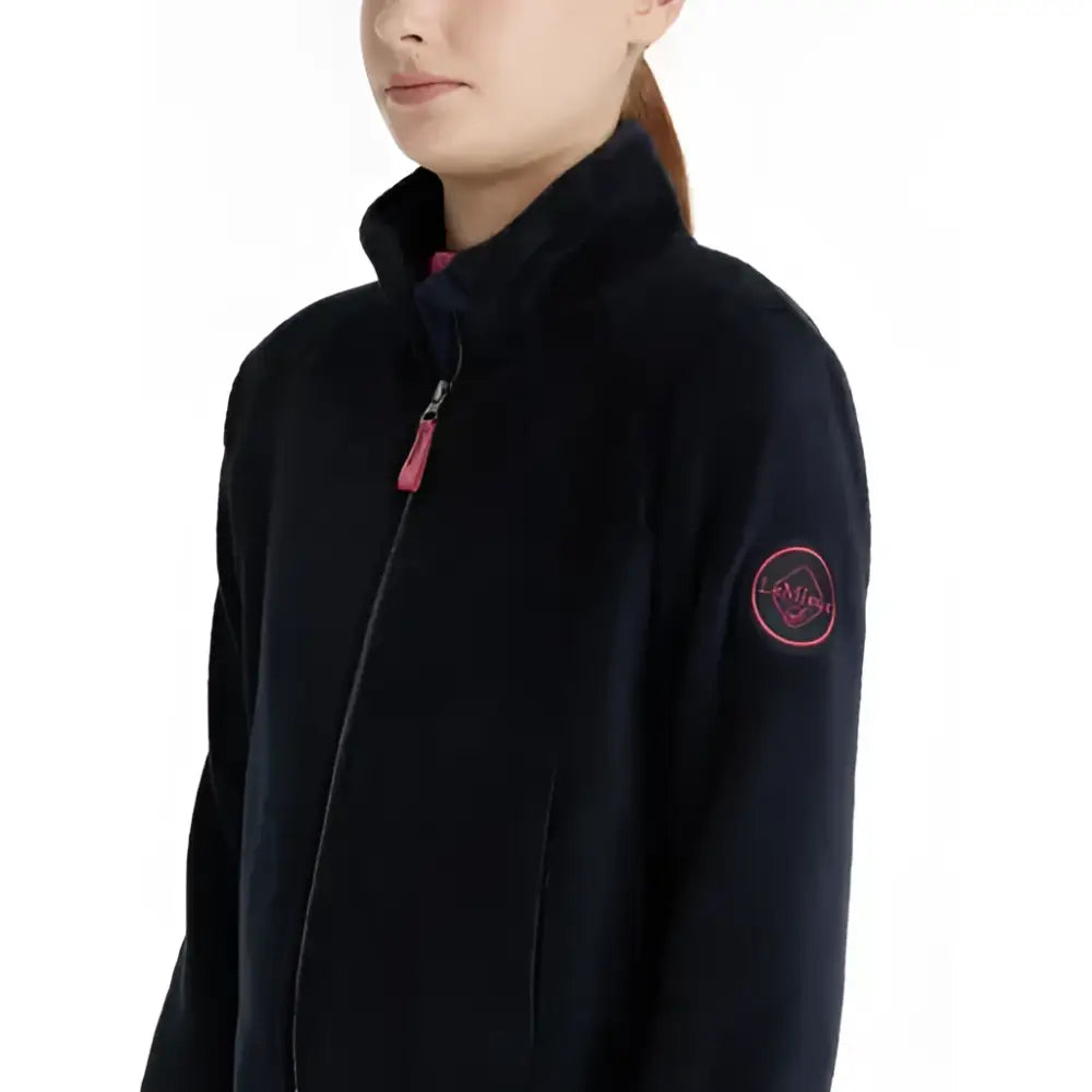 Black lemieux young rider libby fleece navy jacket with pink zipper pull and embroidered logo patch on sleeve