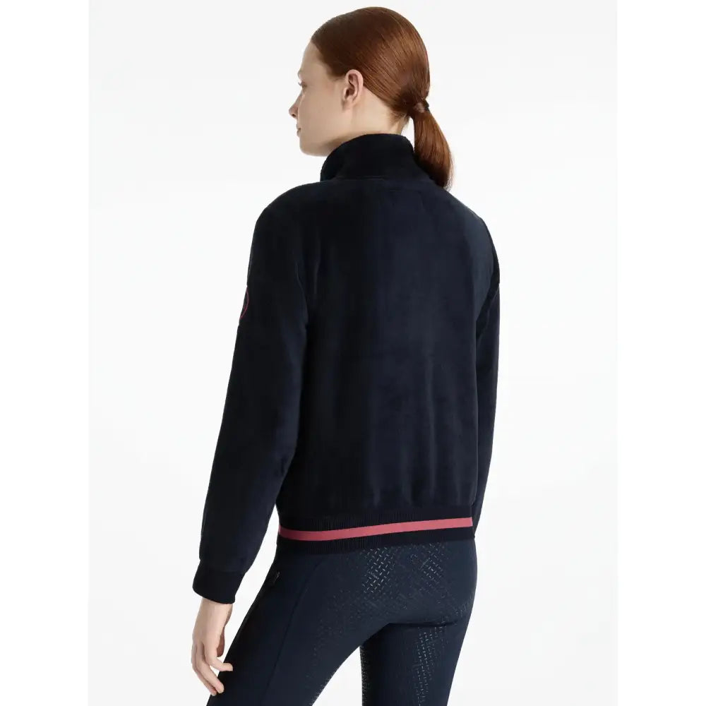 Navy blue lemieux young rider libby fleece navy zip-up jacket with pink trim at waistband perfect for riding