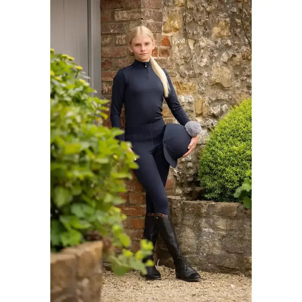 Navy blue long-sleeved lemieux young rider top with high collar and ribbed cuffs for young rider lizzie mesh legging look