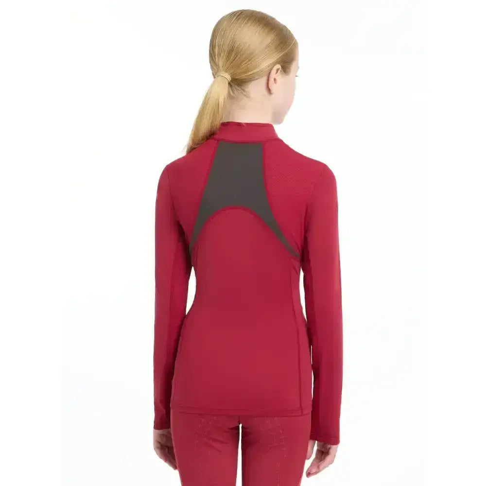 Back view of lemieux young rider mia mesh base layer in red with a dark gray panel perfect for active kids