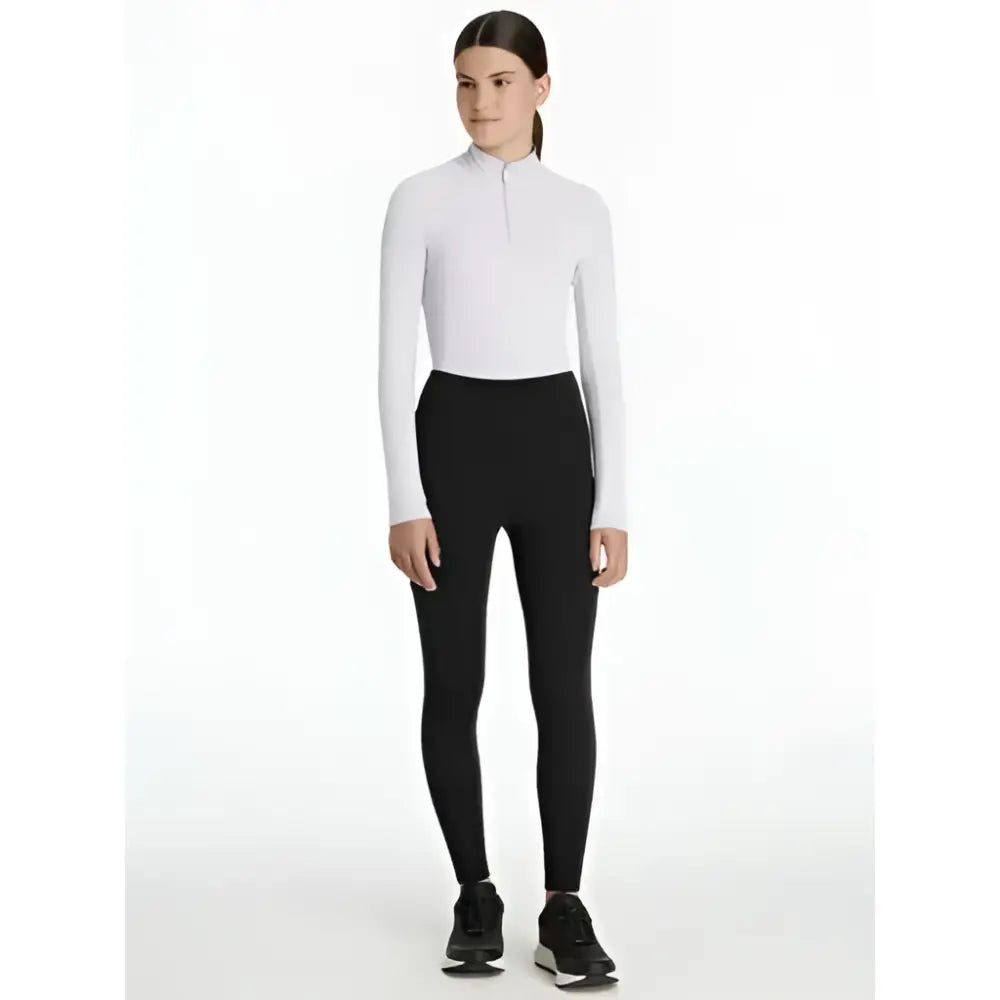 White long-sleeved zip-neck top paired with lemieux young rider nell brushed pull ons black leggings