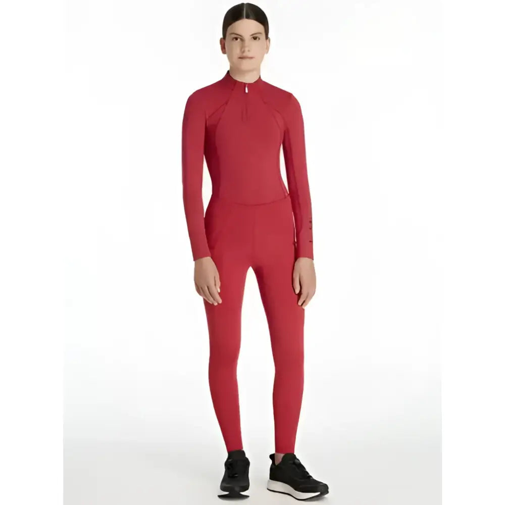 Red long-sleeved high-necked compression suit with zipper and subtle branding on sleeve lemieux young rider orla pull ons