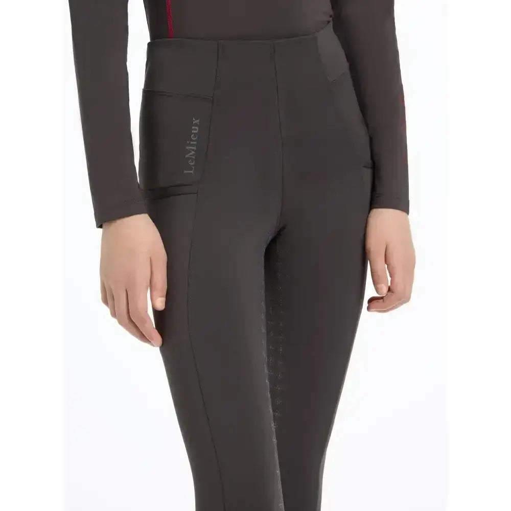 Black lemieux young rider orla pull ons cinder riding pants with sleek fit and subtle red accent stitching on waistband