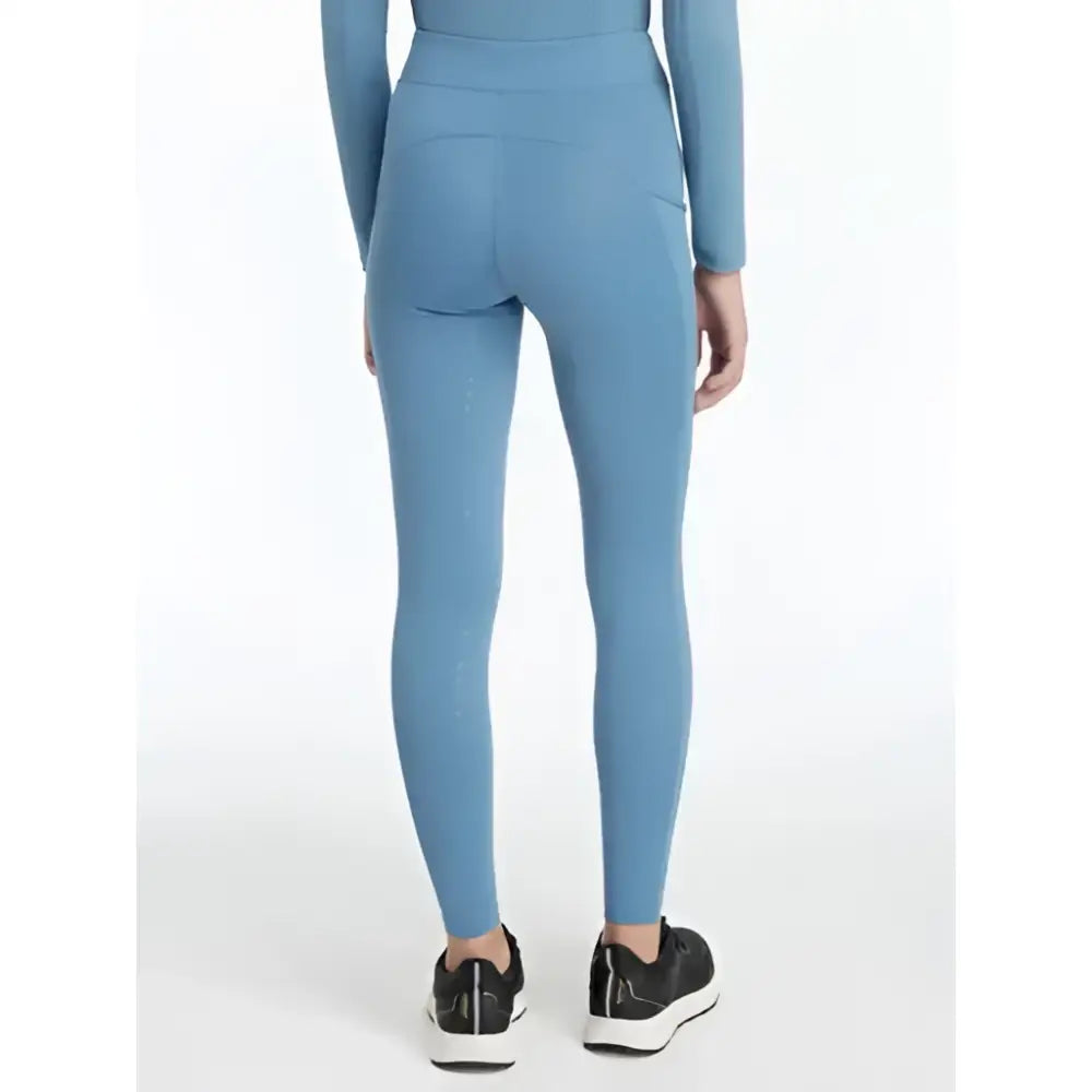 A pair of light blue lemieux young rider orla pull ons ice leggings with side pockets and a high waistband