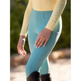 Light blue form-fitting lemieux young rider orla pull ons with subtle seam detail and logo on matching top arm