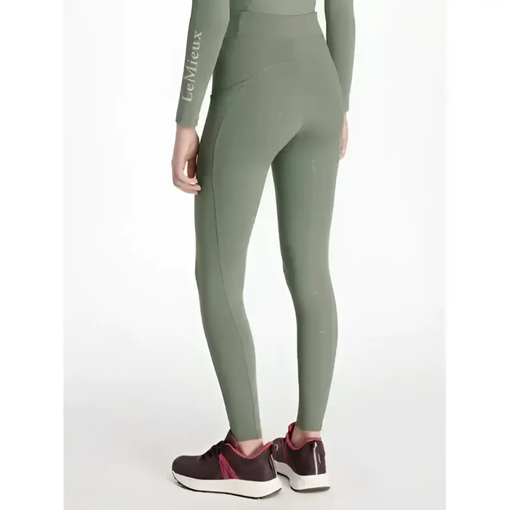Olive green lemieux young rider orla pull ons rosemary leggings with long sleeves and branding on left sleeve