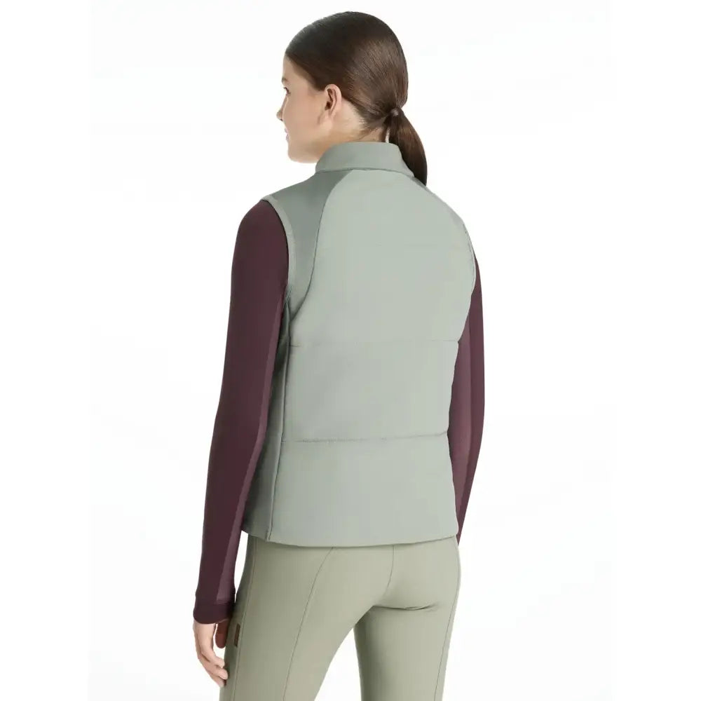A sleek two-tone lemieux young rider pammy training gilet in sage green and burgundy with quilted design