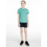 A teal short-sleeved t-shirt with a subtle white logo paired with lemieux young rider penelope shorts navy