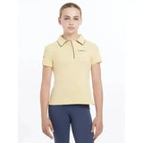 A pale yellow lemieux young rider polo shirt mimosa with black trim and subtle logo embroidery on the left chest
