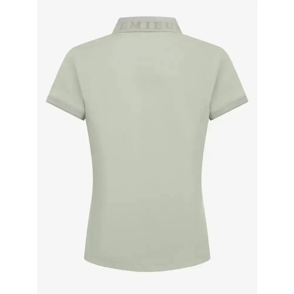 A light sage green lemieux young rider polo shirt pistachio with short sleeves and an embroidered collar logo