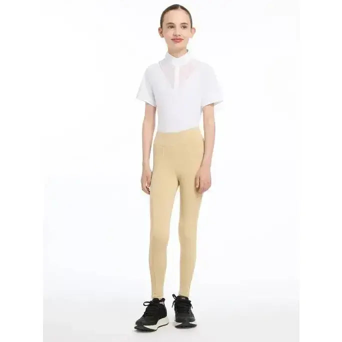 Beige lemieux young rider pull on breech with technical fabric harnesses worn with white polo for active riders