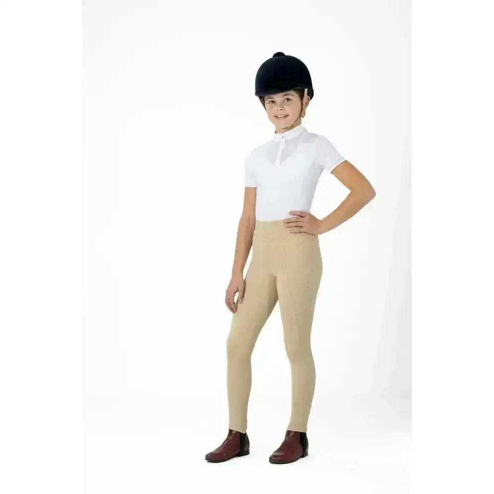 A child wearing beige lemieux young rider pull on breeches with sweat wicking and 4-way stretch fabric