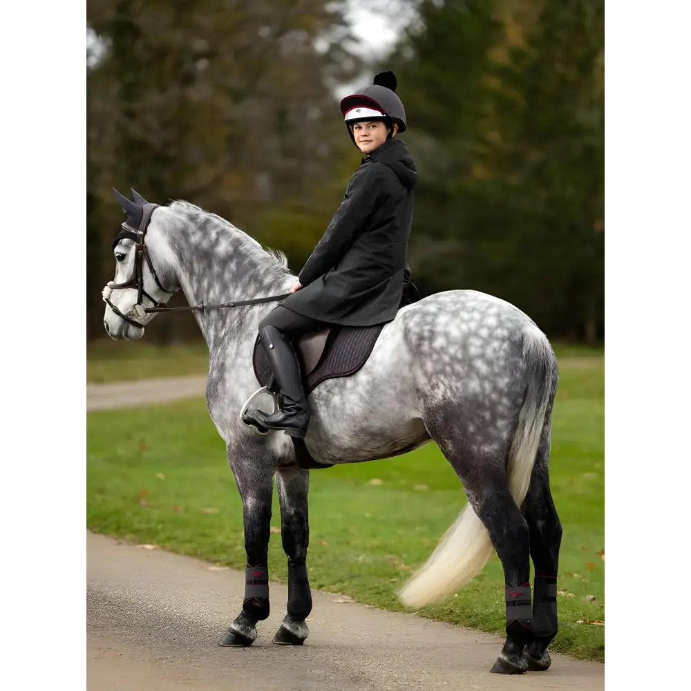 Dappled gray horse and rider in Lemieux Young Rider Skye Waterproof Coat Black