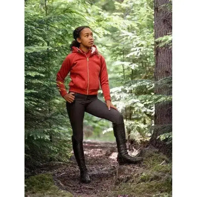 Red zip-up hoodie with white lining paired with lemieux young rider st tropez breeches liquorice and black boots