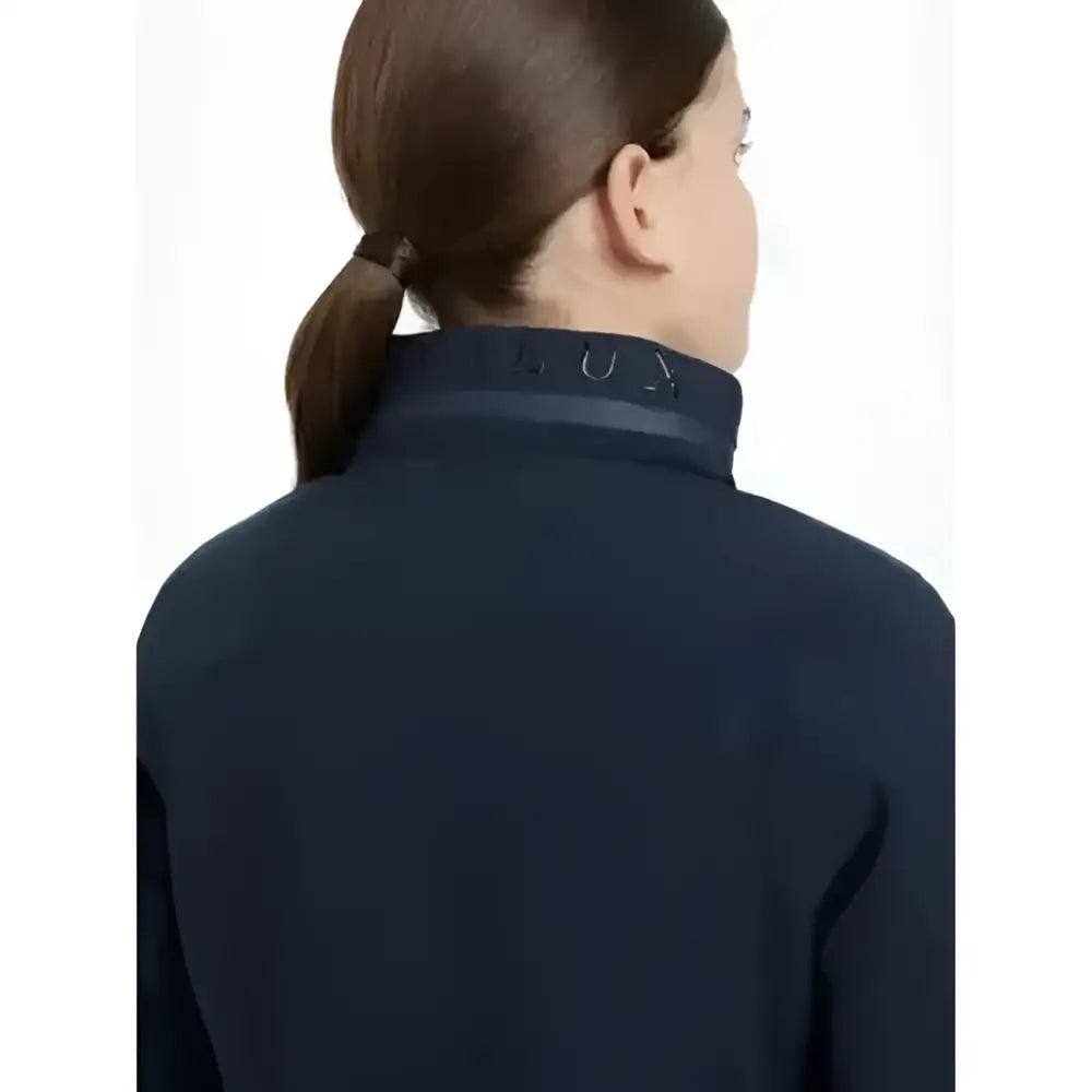 Dark navy blue high neck lemieux young rider team jacket with subtle embroidered logo along the collar