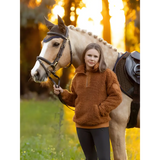 White horse with saddle beside person in Tia Teddy Fleece Ginger cozy sweater