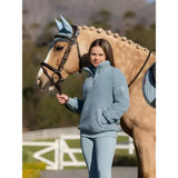 A soft light blue lemieux young rider tia teddy fleece jacket with a half-zip collar and cozy texture