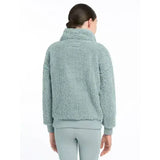 A soft light teal lemieux young rider tia teddy fleece jacket with high collar and ribbed cuffs