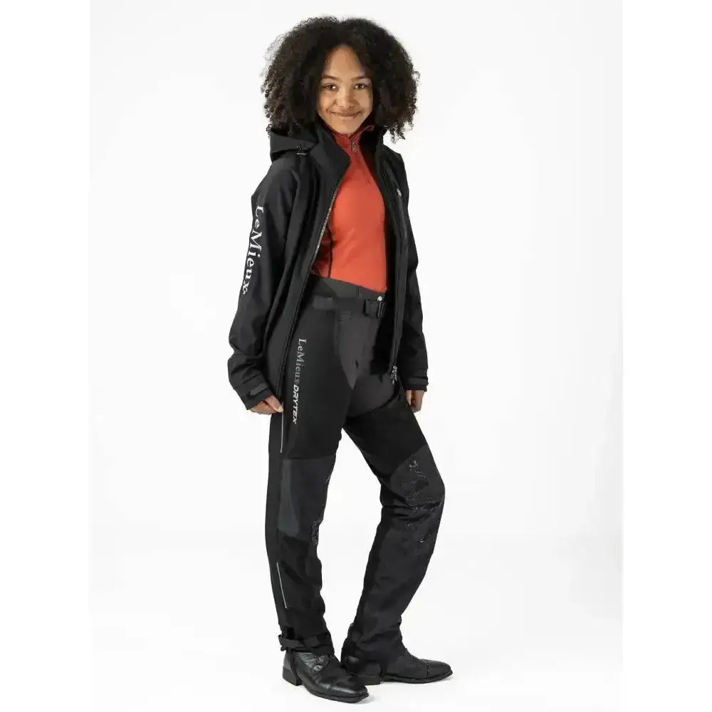 Black lemieux equestrian jacket with white branding and reinforced panels perfect for young rider waterproof use