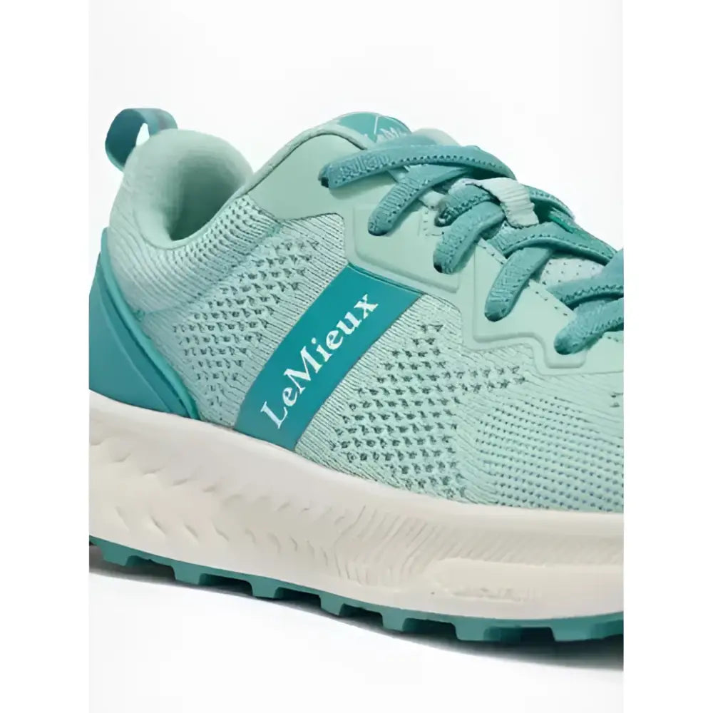 A mint green lemieux youth trainer aqua with breathable mesh upper teal laces and a white midsole for equestrian use