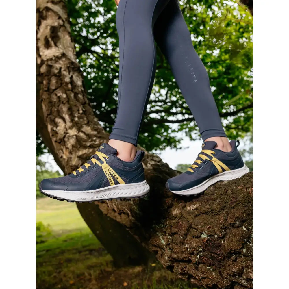 Navy blue and yellow lemieux youth trax viva waterproof trainers with white soles and sleek design in youth trax dusk color