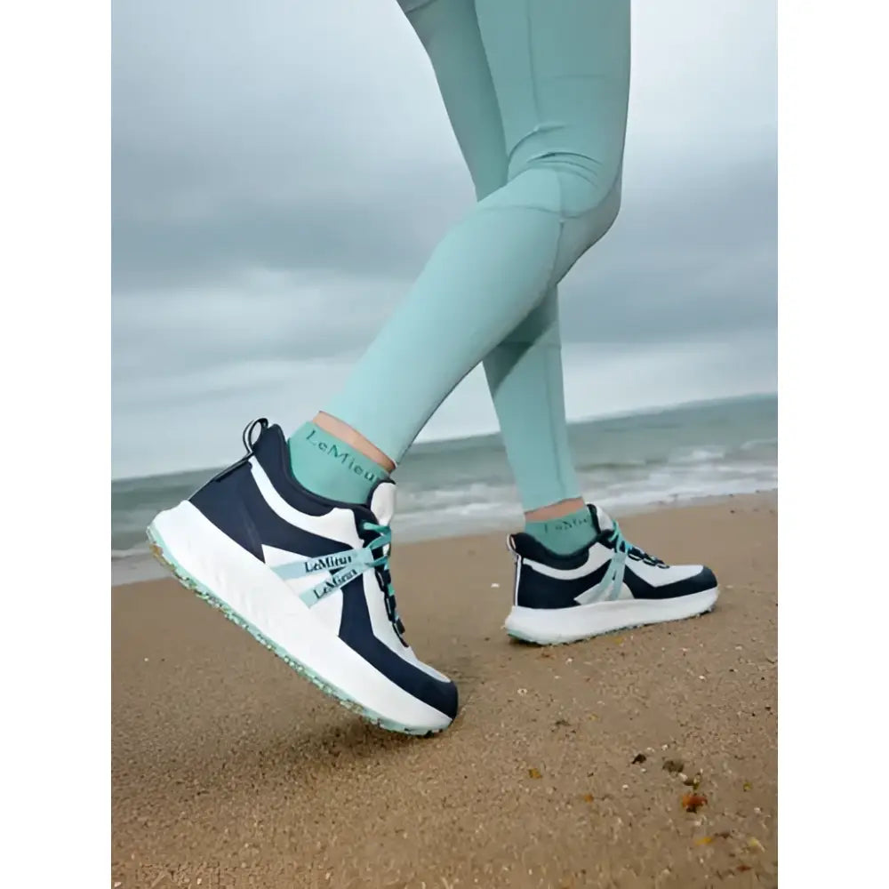 Navy and white lemieux youth trax viva waterproof trainers with teal accents and textured sole for active kids